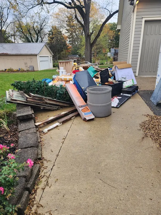 Dumpster being loaded with debris for Estate Cleanout Dumpster Rental in Gresham Park